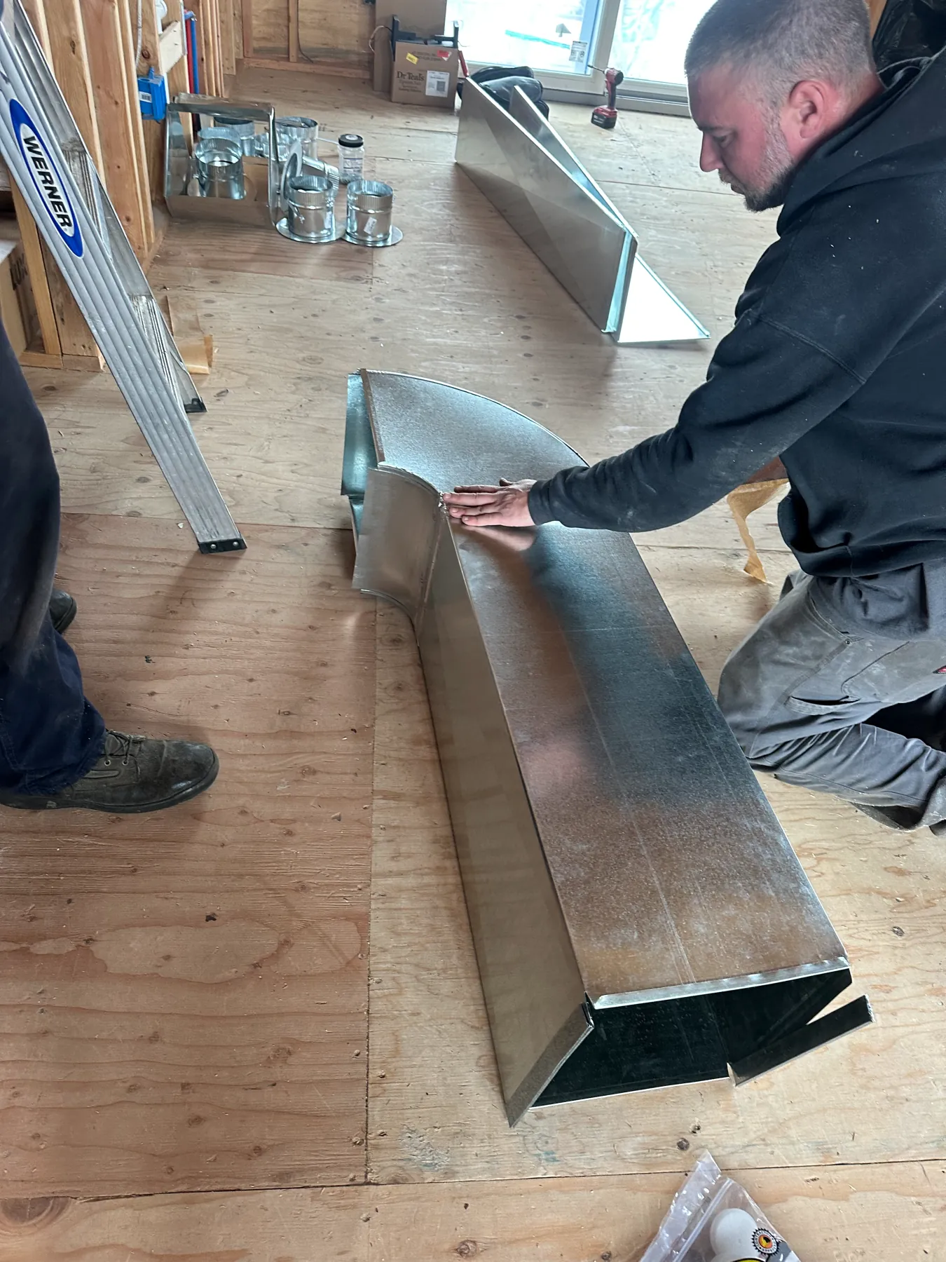 Technician fabricating sheet metal ductwork on site