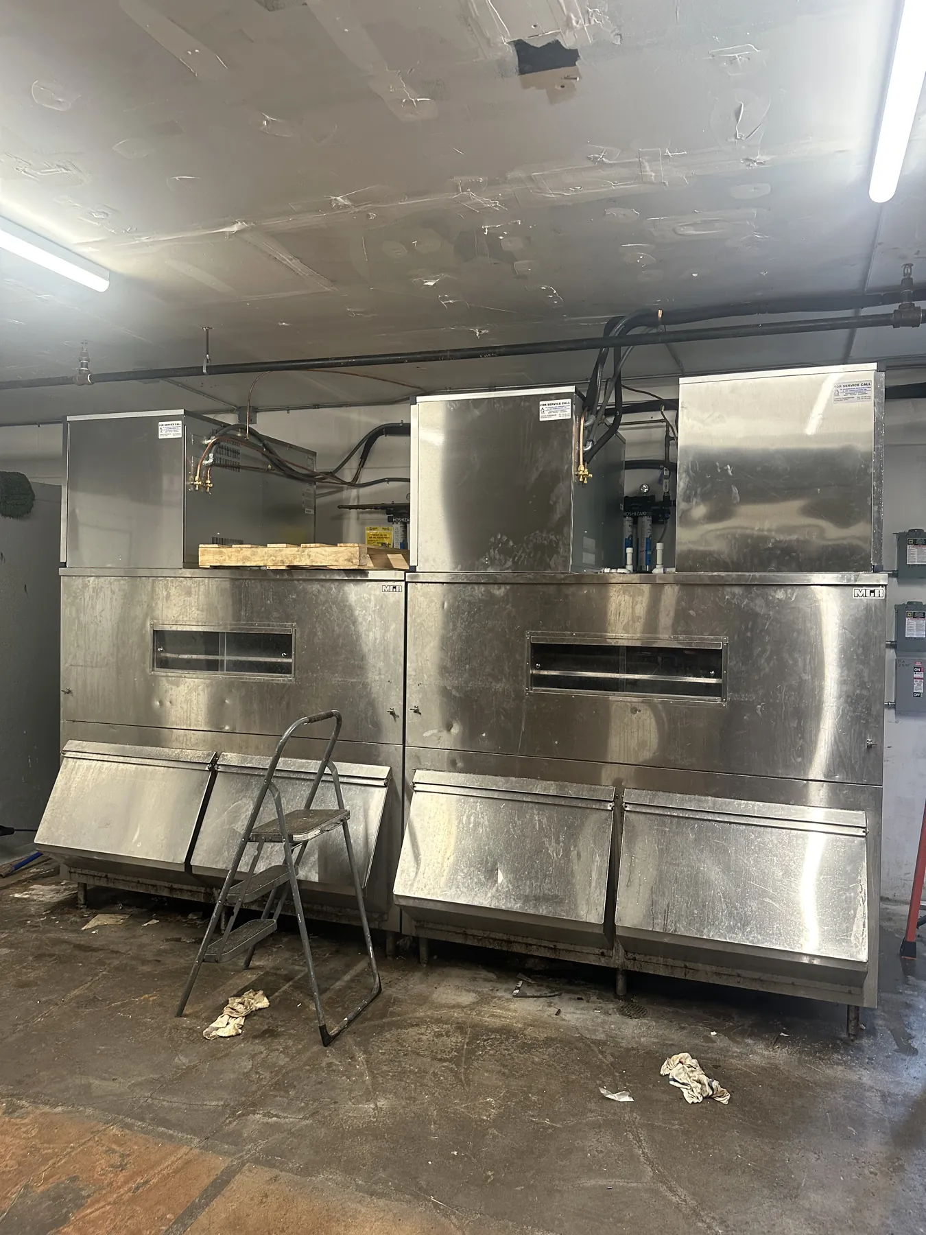 Two finished stainless steel commercial ice machine units