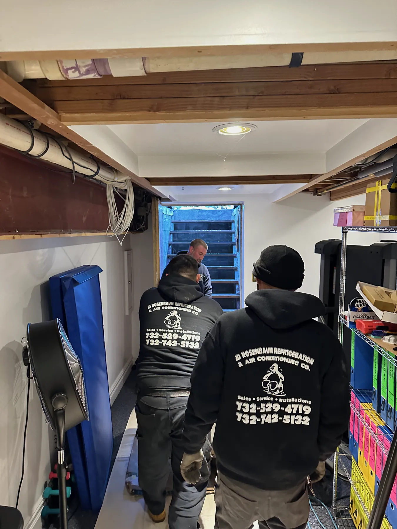 J.D. Rosenbaum Refrigeration & Air Conditioning crew on a job in branded penguin hoodies